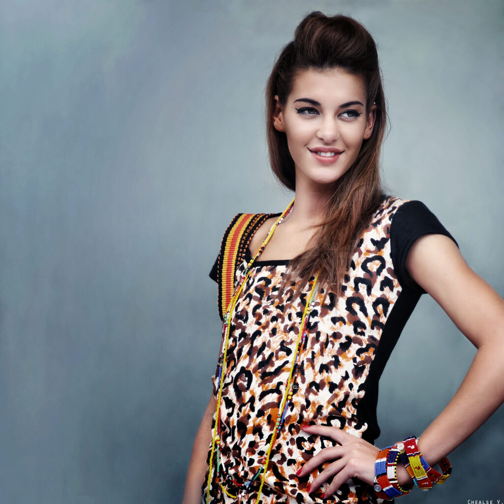 Alicia wearing New Model Beauty Queen dress and Beads For Wildlife jewellery, carrying a Dutzi bag